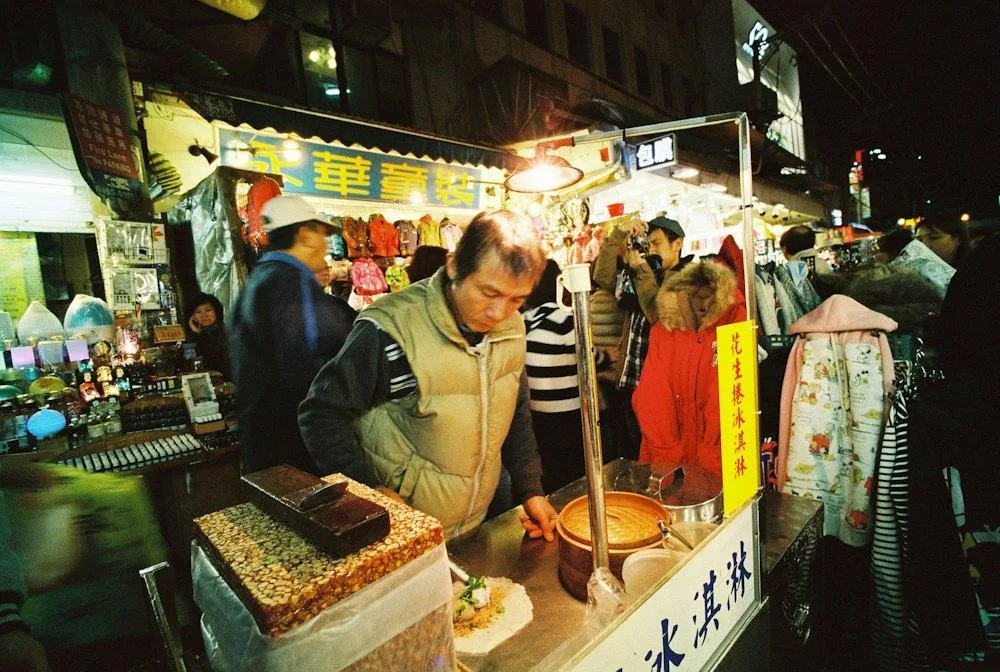 A stall-holder working under a single bulb